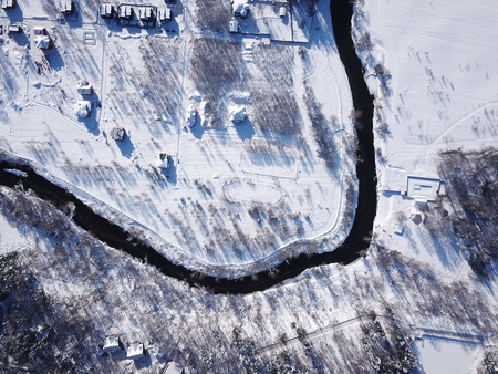 Aerial, Drone View of Snow Covered Evergreen Christmas Tree Forest and house after Snow