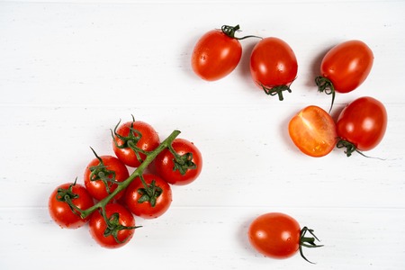 Fresh cherry tomatoes on a white wood background.の写真素材
