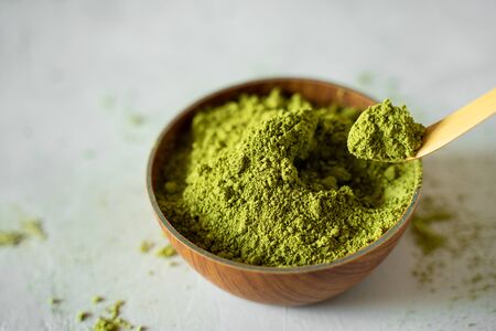 Matcha tea in a brown cup on a gray backgroundの写真素材