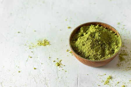 Matcha tea in a brown cup on a gray backgroundの写真素材