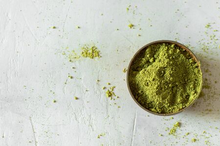 Matcha tea in a brown cup on a gray backgroundの写真素材