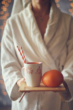 Girl holding a tray of coffee and fruit . Christmas holiday concept. Holiday backgroundの写真素材