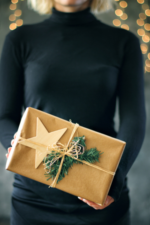 Girl holds a Christmas present. Christmas conceptの写真素材