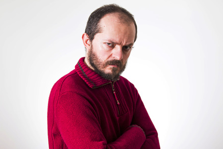 Portrait of angry man, in red sweater, with beard and mustaches