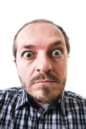 Surprised man in plaid shirt, eyes wide openの写真素材