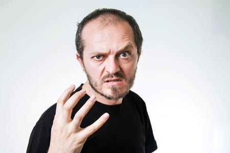 Aggressive man with beard and mustaches, threateningの写真素材