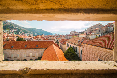 Roofs and churches of the old town Dubrovnik, Croatia, view through the stone wallsの写真素材
