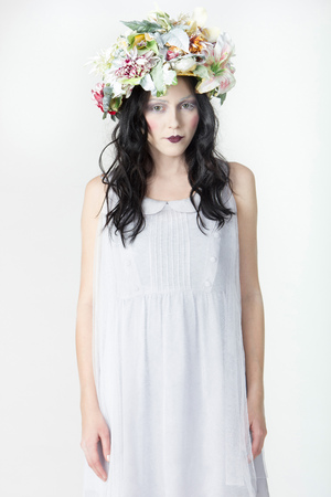 Portrait of Young Woman with Wreath of Flowers on white Background. Beauty Concept.の写真素材