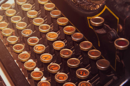 Antique vintage typewriter on the desk, old and rusty, keys close up, selective focus, retro filterの写真素材