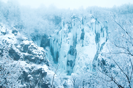 Frozen waterfalls in mist in nature park Plitvice, Croatiaの写真素材
