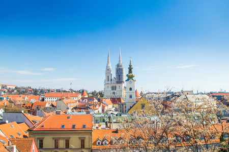 Spring in Zagreb, Croatian capital - city skyline, catholic cathedral and red roofs in city center, view from Upper townの写真素材