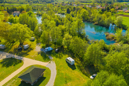 Croatia, green countryside, Mreznica river from air, panoramic view of Belavici village, waterfalls in spring, popular tourist camping resort destinationの写真素材