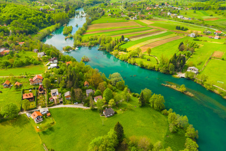 Croatia, green countryside, Mreznica river from air, panoramic view of Belavici village, waterfalls in spring, popular tourist camping resort destinationの写真素材