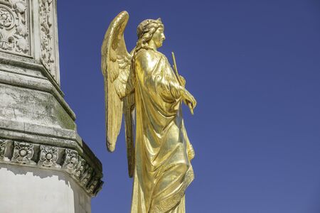 Mary column with golden angels statues in front of cathedral in Zagreb, Croatia, blue skyの写真素材