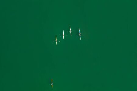 Water sports, Croatia, Zagreb city, panoramic aerial view of Jarun lake from drone, overhead view, unrecognizable people paddling in kayak on beautiful green lakeの写真素材