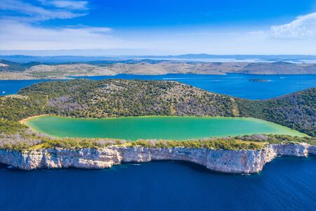 Aerial view of the Salt lake in nature park Telascica, Croatia, Dugi otok, big stone cliffs above...