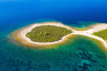 Rocky fish shaped cape in turquoise sea, clear blue water on the island of Dugi Otok in Croatia
