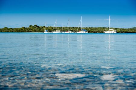 Island of Dugi Otok in Croatia, beautiful old boat anchored on Adriatic sea archipelagoの写真素材
