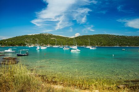 Scenic view of Kosirina beach bay on Murter island in Croatia, sailing boats and yachts on blue seaの写真素材