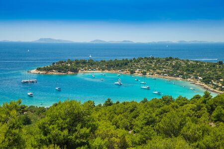 Panoramic view on Kosirina beach lagoon on Murter island in Croatia, anchored sailing boats and yachts on blue seaの写真素材