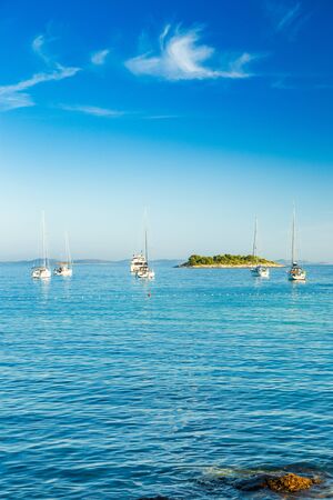 Yachting on Adriatic sea in Croatia, sailing boats and yachts in the morning in blue bay lagoon on Murter islandの写真素材