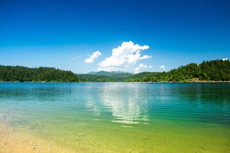 Croatia, beautiful blue lake in Gorski kotar, Lokve, Croatia, with Risnjak mountain in background, reflection in watterの写真素材