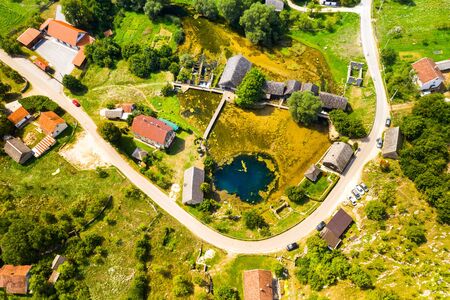 Croatia, region of Lika, Majerovo vrilo river source of Gacka and old wooden mills and cottages aerial drone viewの写真素材