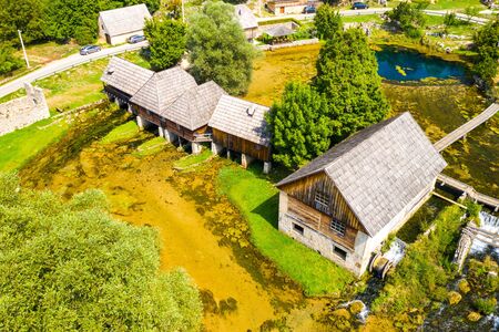 Croatia, countryside region of Lika, Majerovo vrilo river source of Gacka and old wooden mills and cottages aerial drone viewの写真素材
