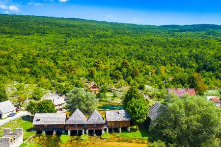 Croatia, countryside region of Lika, Majerovo vrilo river source of Gacka and old wooden mills and cottages aerial drone viewの写真素材