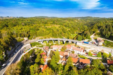 Croatia, Cetina river source water hole and small Orthodox church in Dalmatian Zagora, aerial drone viewの写真素材