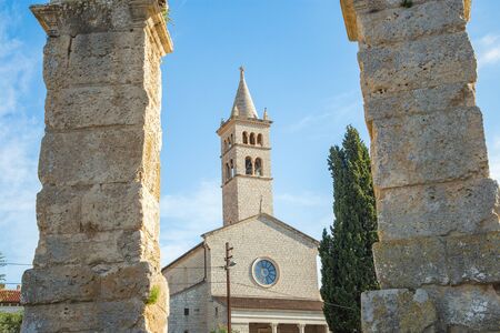 Ancient heritage in Pula, Istria, Croatia. Arches of monumental Roman arena. Detail of historic amphitheater, wide angle view of walls on blue sky background.の写真素材