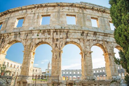 Big stone arches of monumental ancient Roman arena in Pula, Istria, Croatiaの写真素材