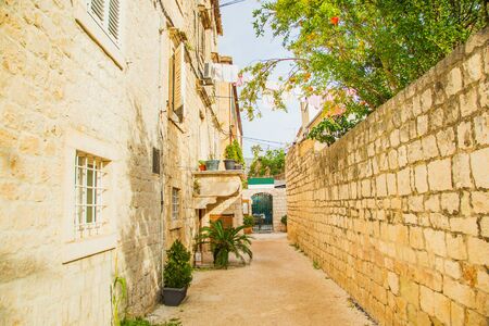 Croatia, Dalmatia, beautiful old street and traditional houses in the old historical town of Trogirの写真素材