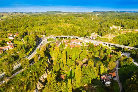 Croatia, Rastoke, road bridge and old water mills on waterfalls of Korana river, beautiful countryside landscapeの写真素材