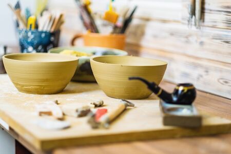 Tools on pottery studio table, shallow debt of field, small art business conceptの写真素材
