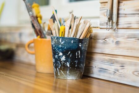 Tools on pottery studio table, shallow debt of field, small art business concept