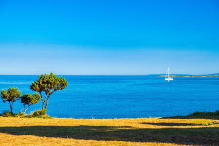 Croatia, beautiful Adriatic seascape shore on Dugi Otok island, sailing boat on horizon on Veli Ratの写真素材