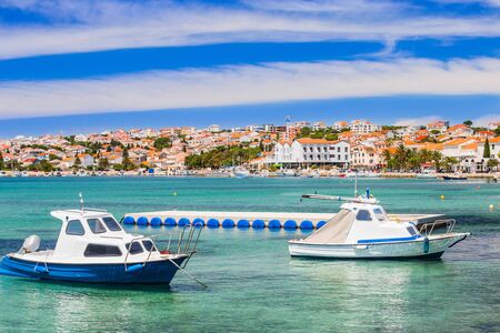 Croatia, Adriatic coastline, waterfront in of the town of Novalja on the island of Pag, turquoise sea in foreground, famous tourist destination.の写真素材