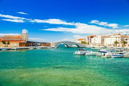 Beautiful town of Pag on Adriatic sea in Dalmatia, Croatia, old stone bridge, waterfront and marina with boatsの写真素材