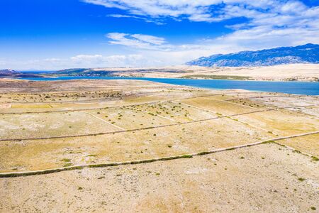 Croatia, Adriatic island of Pag, panoramic view of old agriculture fields and beautiful stone walls, Velebit mountain in backgroundの写真素材