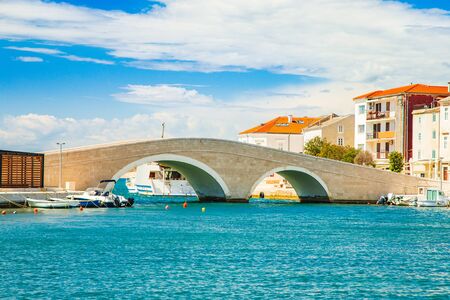 Beautiful town of Pag in Dalmatia, Croatia, view of marina and old stone bridgeの写真素材