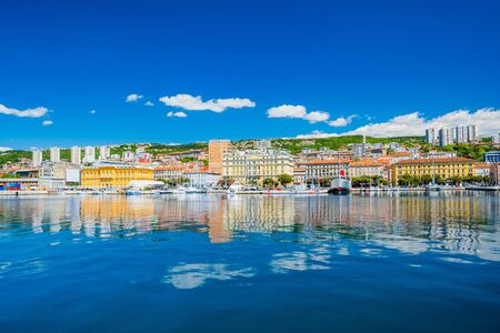 Waterfront view of the city of Rijeka, Croatia. Boats in marina and old classic monumental buildings in background.の写真素材