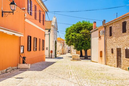 Cobbled square and old street with stone well in the historic town of Nin in Dalmatiaの写真素材