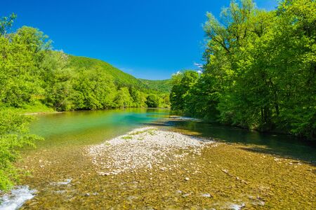Croatia, beautiful landscape in spring, canyon of Kupa river in Gorski kotar, mountains in backgroundの写真素材