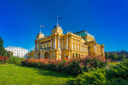 Croatian national theater building and flowers in park in Zagreb, Croatiaのeditorial素材