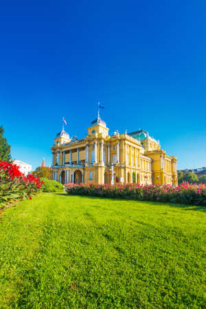Croatian national theater building and flowers in park in Zagreb, Croatiaのeditorial素材
