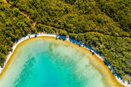 Aerial overhead view of beautiful lagoon on Adriatic sea in Croatia, Dugi Otok island. Pine woods, long hidden beaches and emerald sea surfaceの写真素材