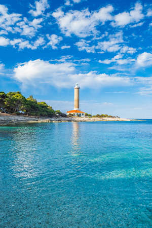 Lighthouse of Veli Rat on the island of Dugi Otok, Croatia, beautiful sea bay in foregroundの写真素材