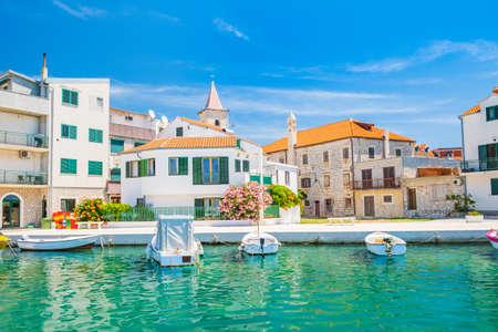 Croatia, Adriatic coastline, coastal town of Pirovac, waterfront view of old buildings and boats in harbourのeditorial素材