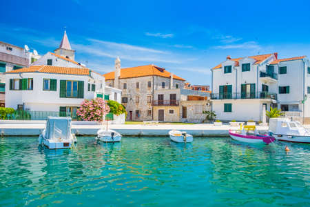 Croatia, Adriatic coastline, coastal town of Pirovac, waterfront view of old buildings and boats in harbourのeditorial素材